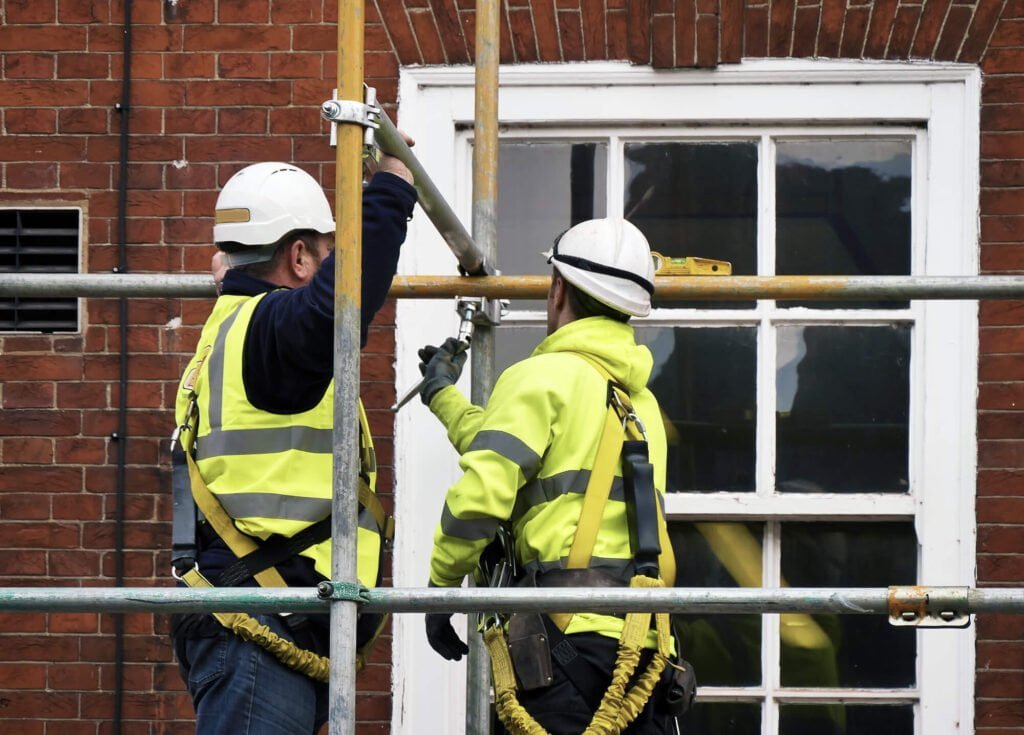 2 men working on a scaffold