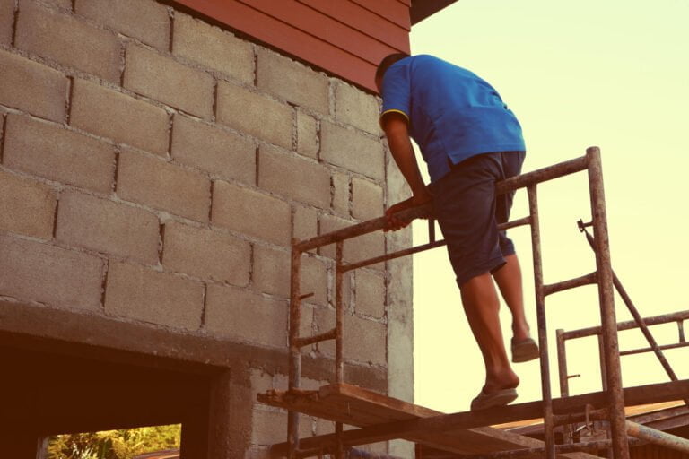 man climbing a scaffold