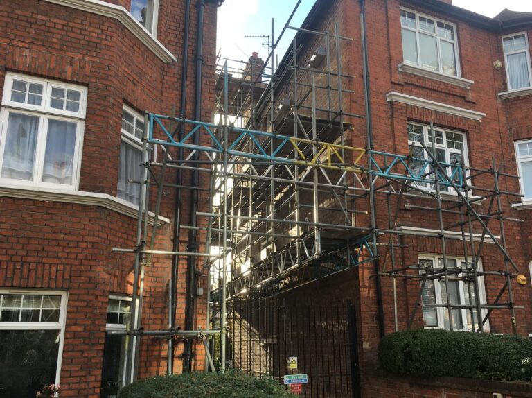 scaffold reaching a chimney on a roof level