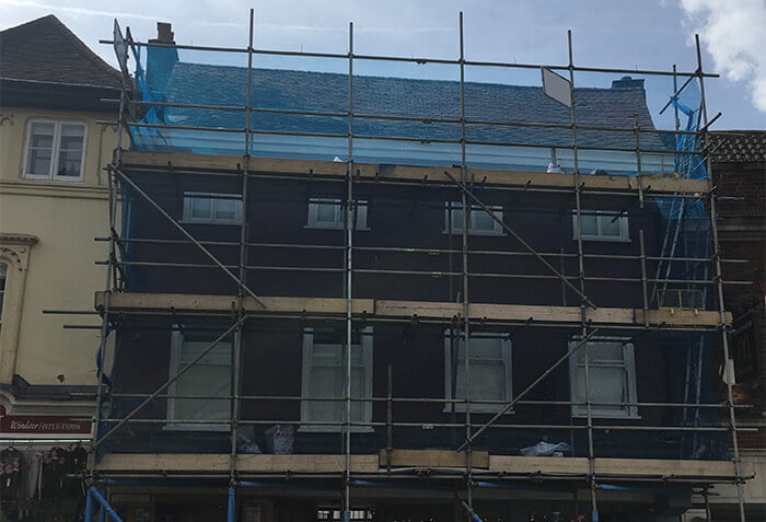 erected scaffold covered with netting