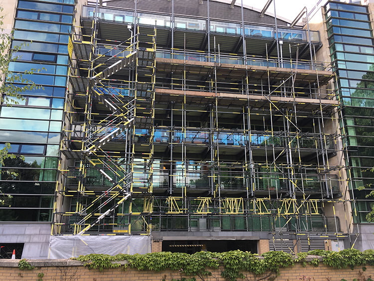 office building covered with scaffold