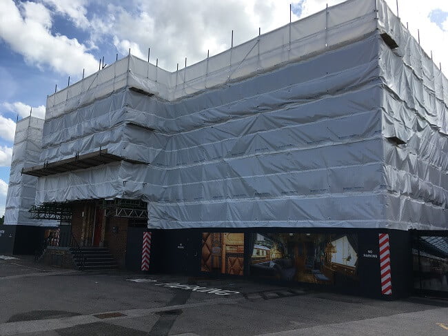 building covered with white scaffold sheeting