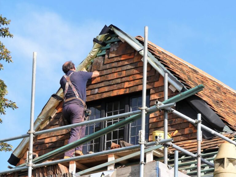 Man working on a roof from scaffolding