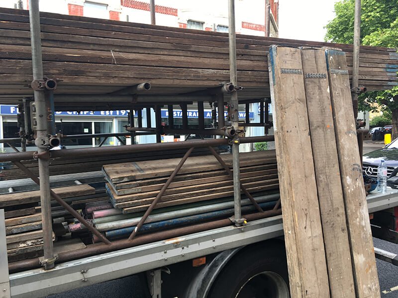 Multiple scaffold boards loaded in a truck.