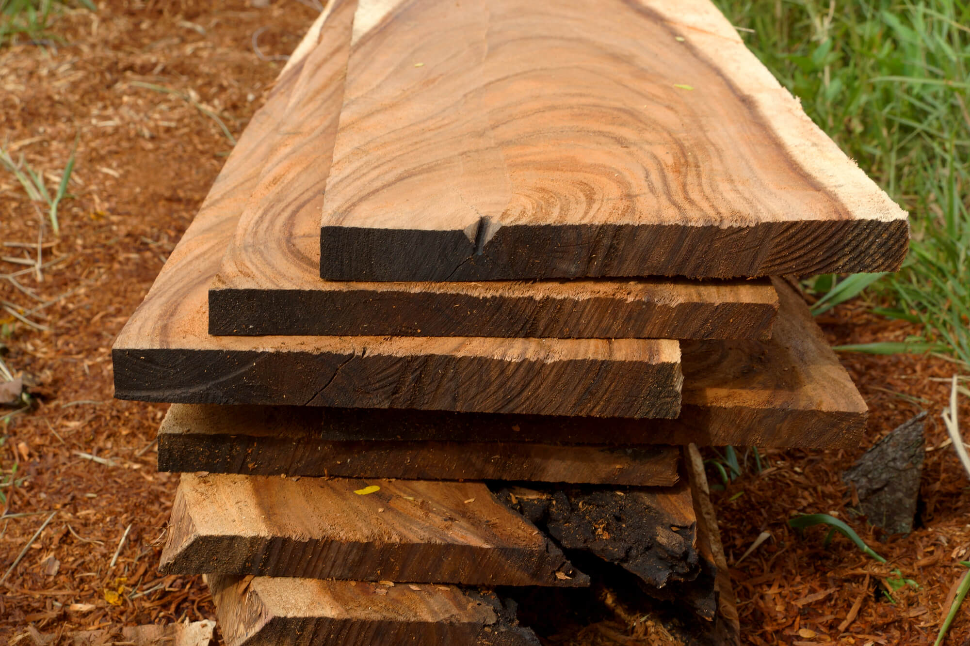 Pile of wood planks on the ground