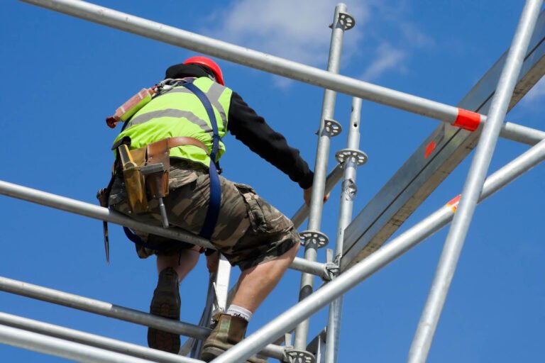 scaffolder erecting scaffold whiles wearing safety gears