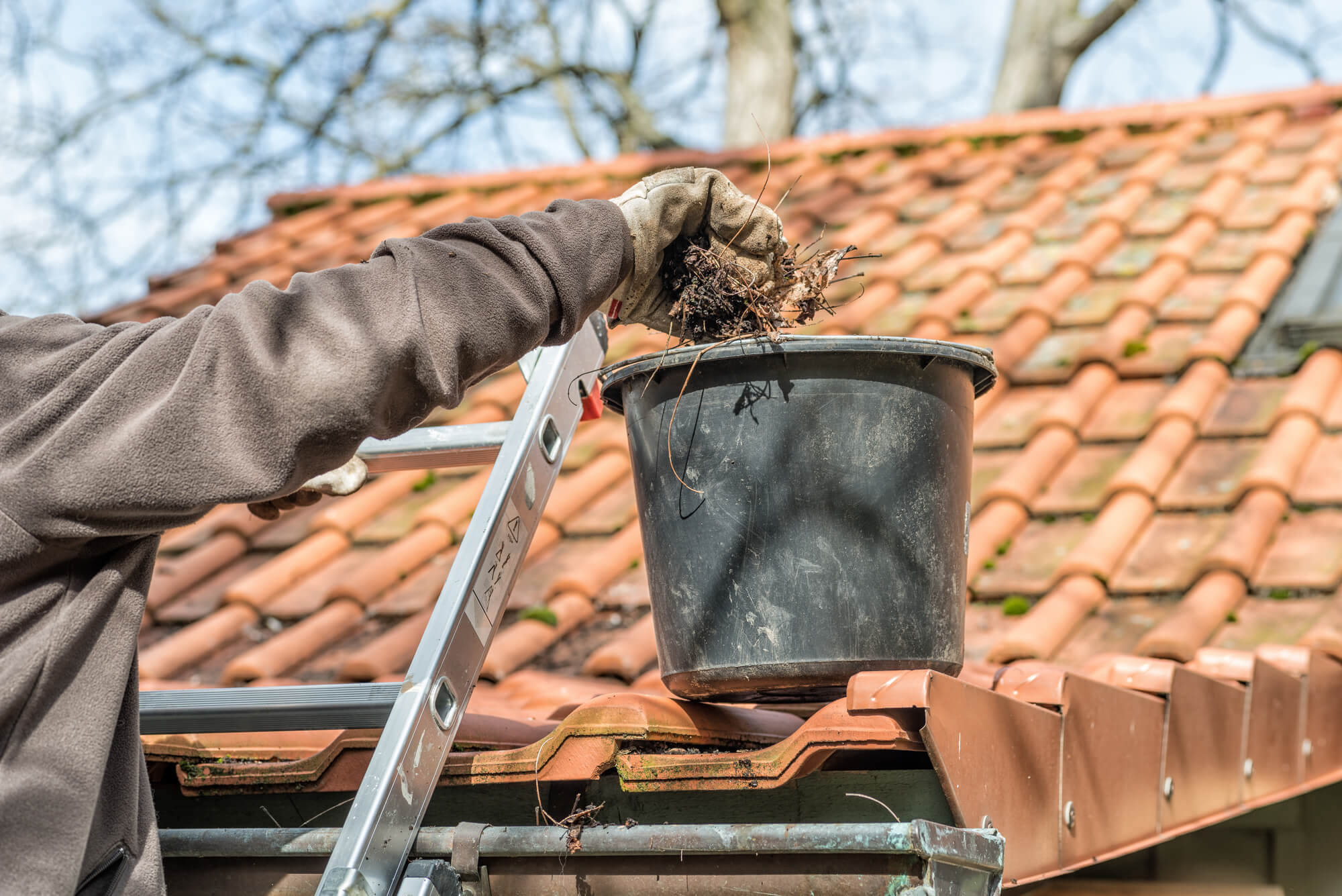 Man hand is cleaning a gutter