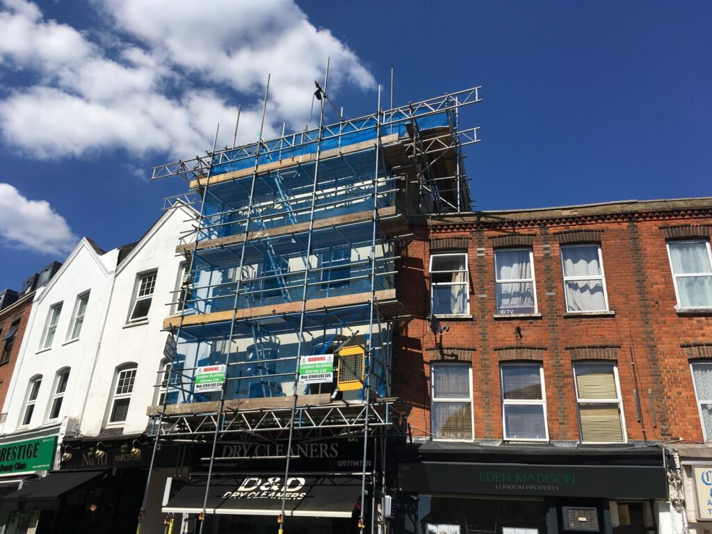 Tall scaffolding tower in blue nets