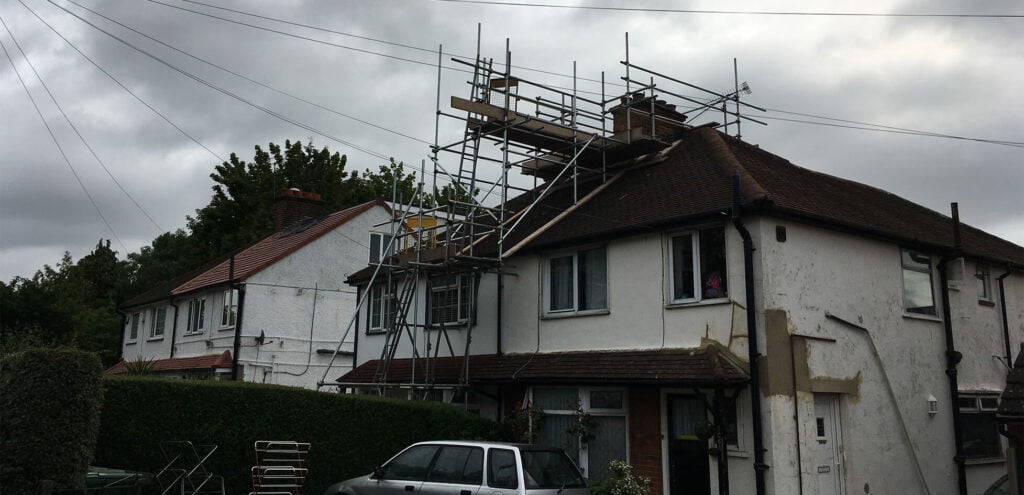 Scaffolding erected and secured against the house